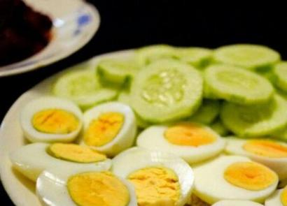 Simple salad of cucumbers with eggs and herbs